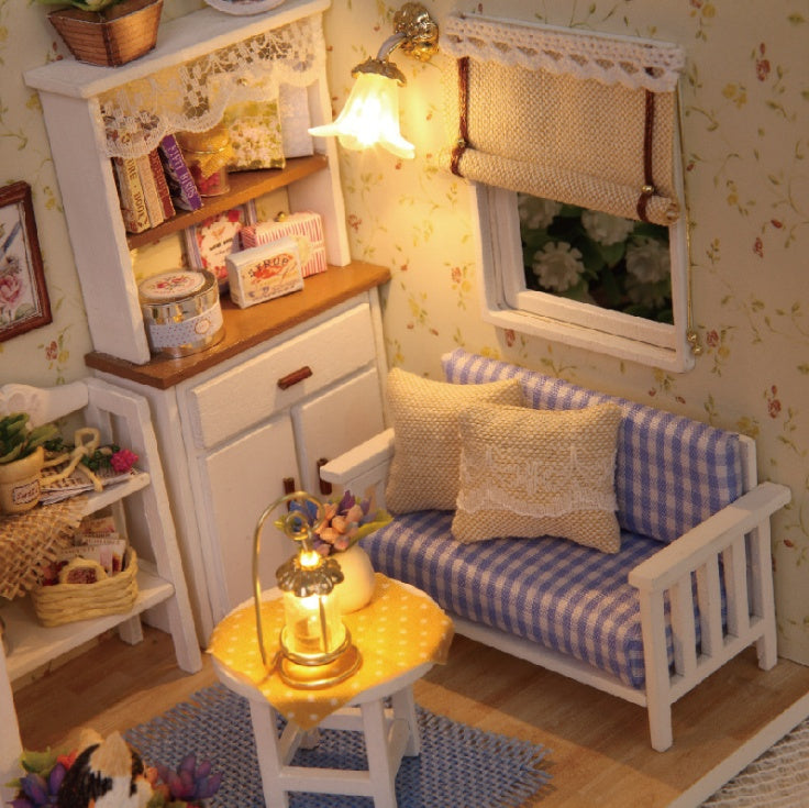 Cozy living room scene from a Miniature Doll House featuring a sofa and decorative lamp