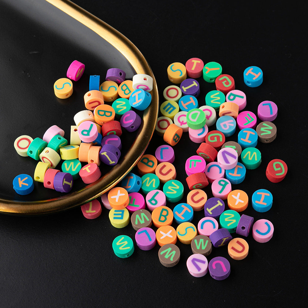Colorful alphabet beads for arts and crafts use in a bracelet kit by Arts And More on black background