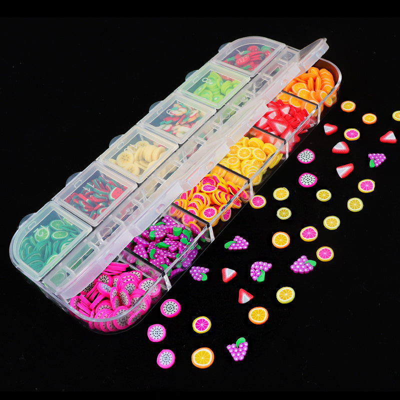 Assorted Nail Jewelry in a clear organizer featuring colorful fruit and shapes for creative nail art