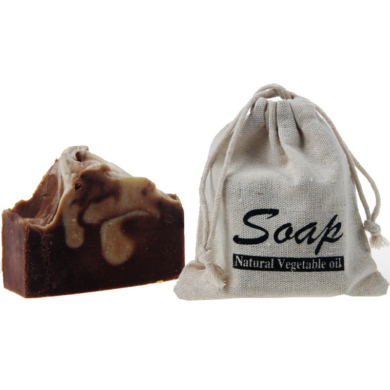 Arts And More Coffee Essential Oil Soap with natural vegetable oil next to a drawstring cotton bag