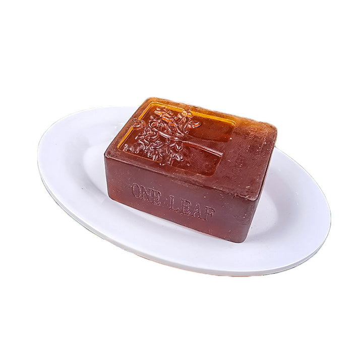Arts And More Anti-Hair Loss Soap bar with leaf design on white dish for hair care