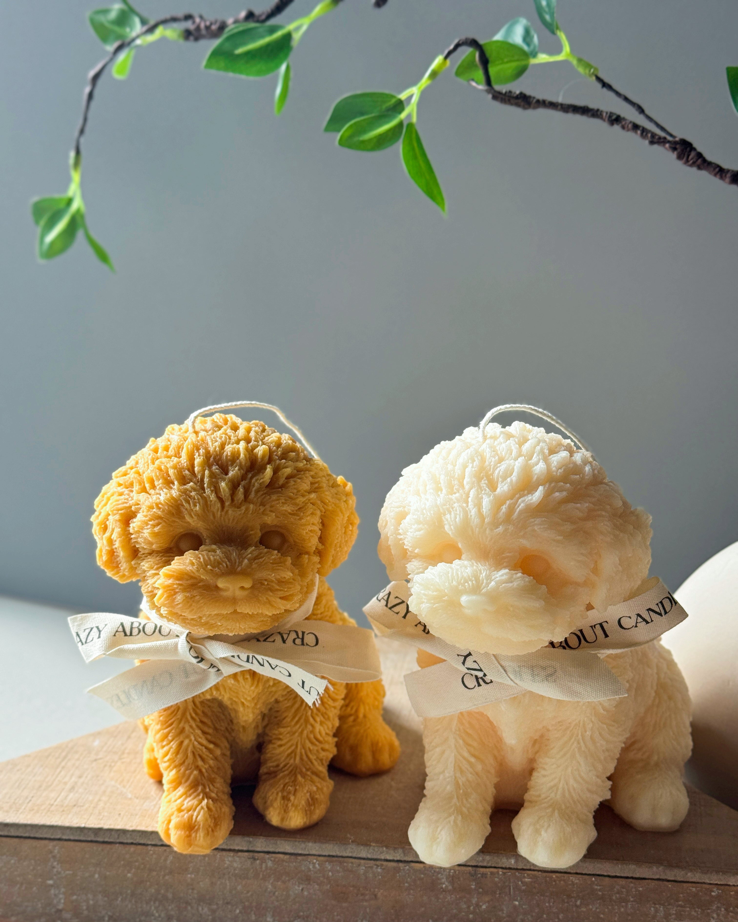 Set of two cute Puppy Candles in cream and yellow, adorned with decorative ribbons from Crazy About Candles