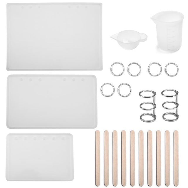 Arts And More resin jewelry silicone molds with mixing cups, metal rings, and wooden sticks for crafting