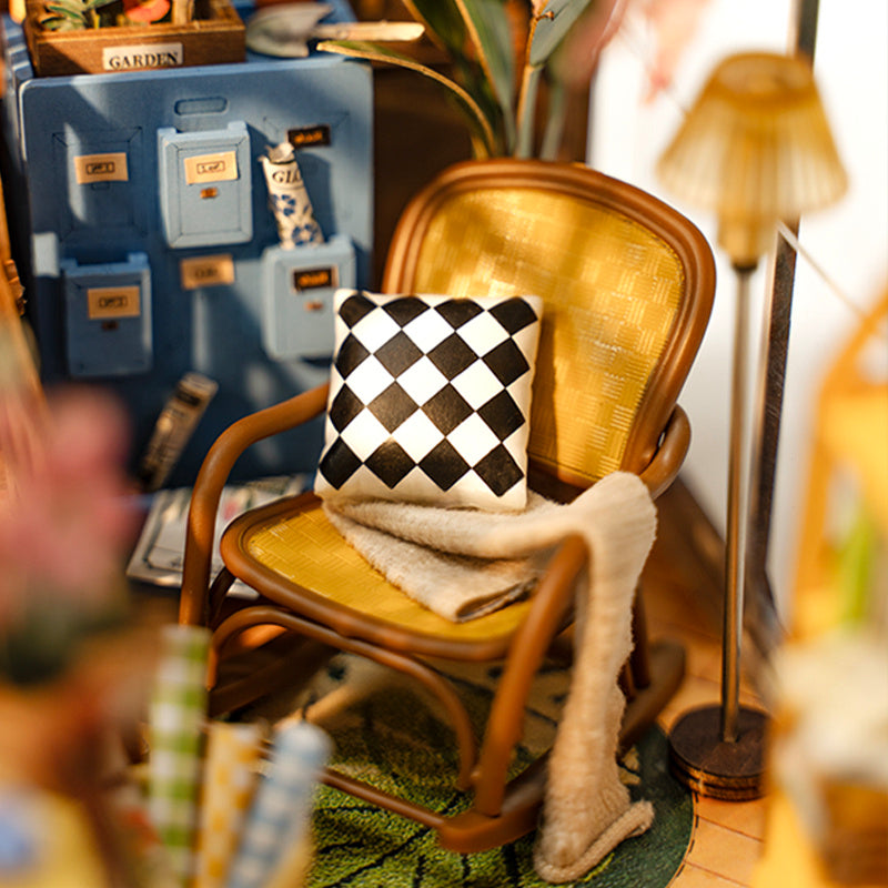 Cozy interior of the Rolife Garden House Book Nook Kit with a stylish chair and decor