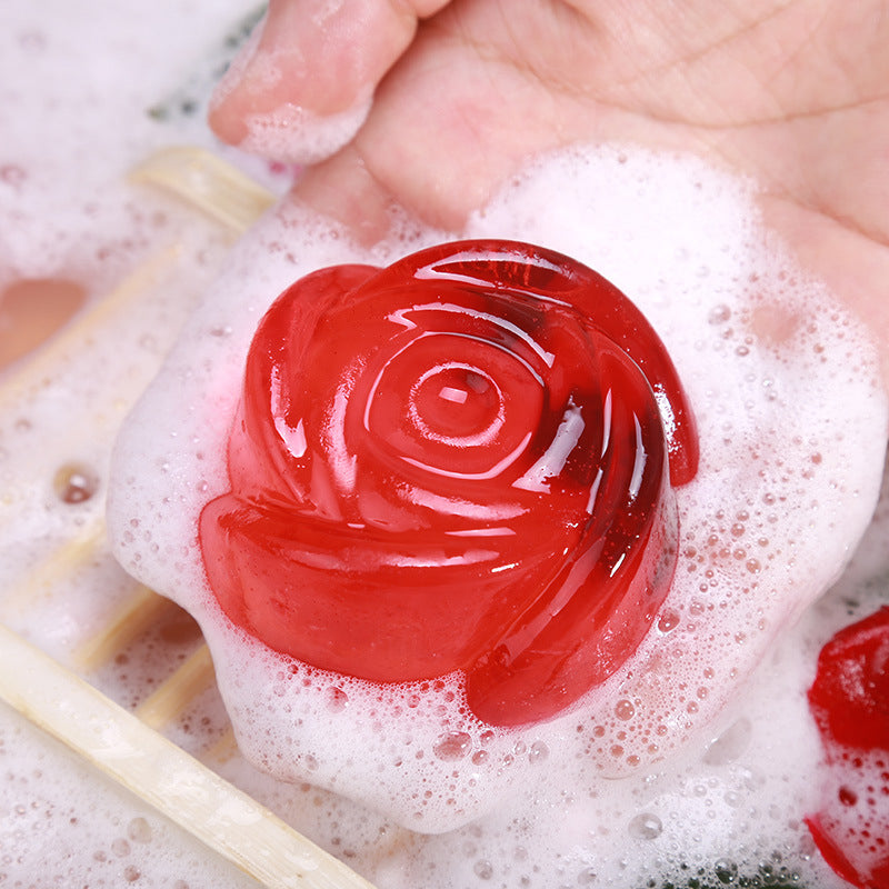 Red rose-shaped Rose Oil Soap from Arts And More held in hand with white foam bubbles