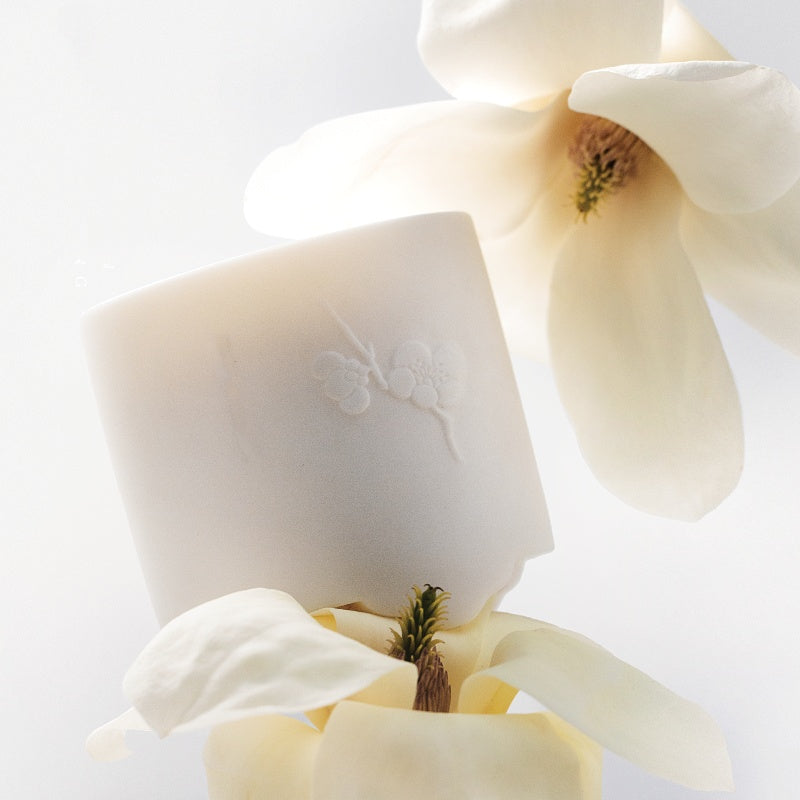 Elegant Snow Moon Scented Candles surrounded by delicate flower petals for a soothing ambiance