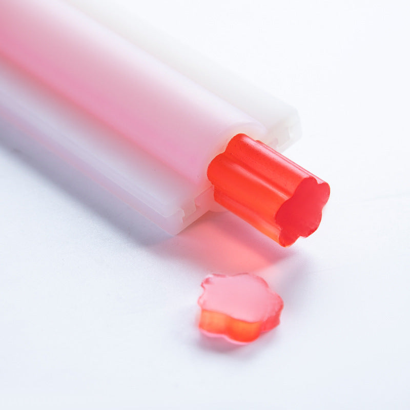 Red flower-shaped soap piece made using Arts And More Soap Silicone Mold on white background