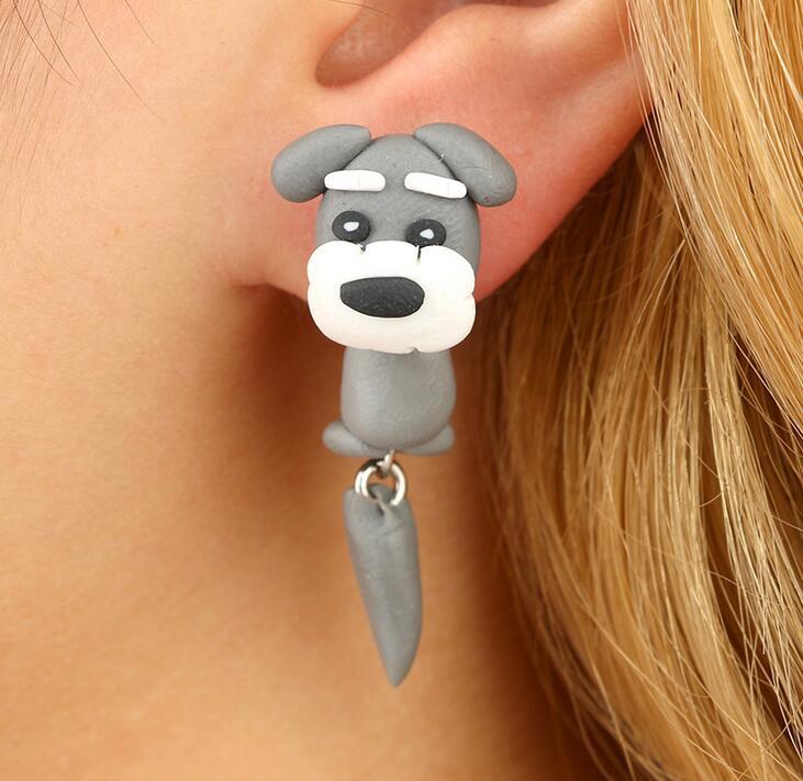 Arts And More soft clay earrings shaped like a gray dog worn on ear