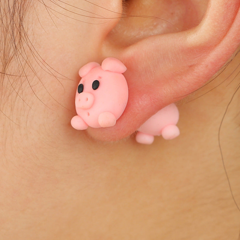 Pink pig-shaped Soft Clay Earrings worn on ear by Arts And More as cute decorations