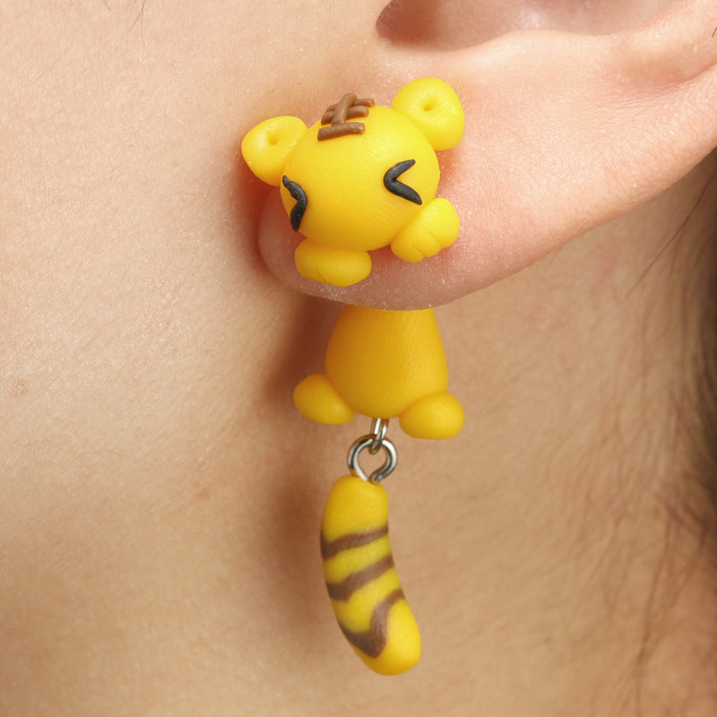 Yellow tiger shaped Soft Clay Earrings hanging from ear by Arts And More
