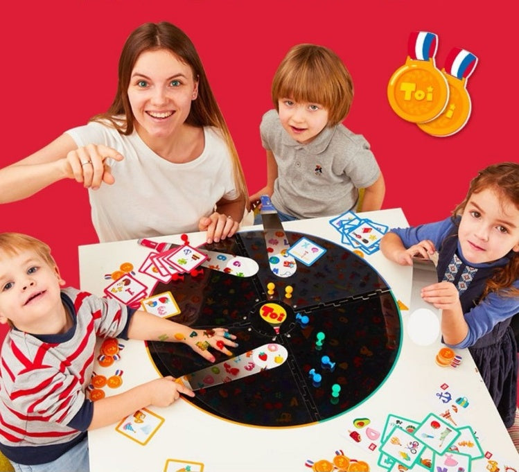 Family playing Find It Table Game arts and crafts kit by Arts And More on white table
