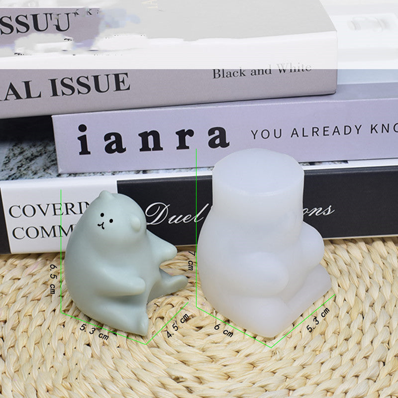 Candle Silicone Diy Mold with a cute bear and a round shape on a woven mat next to books