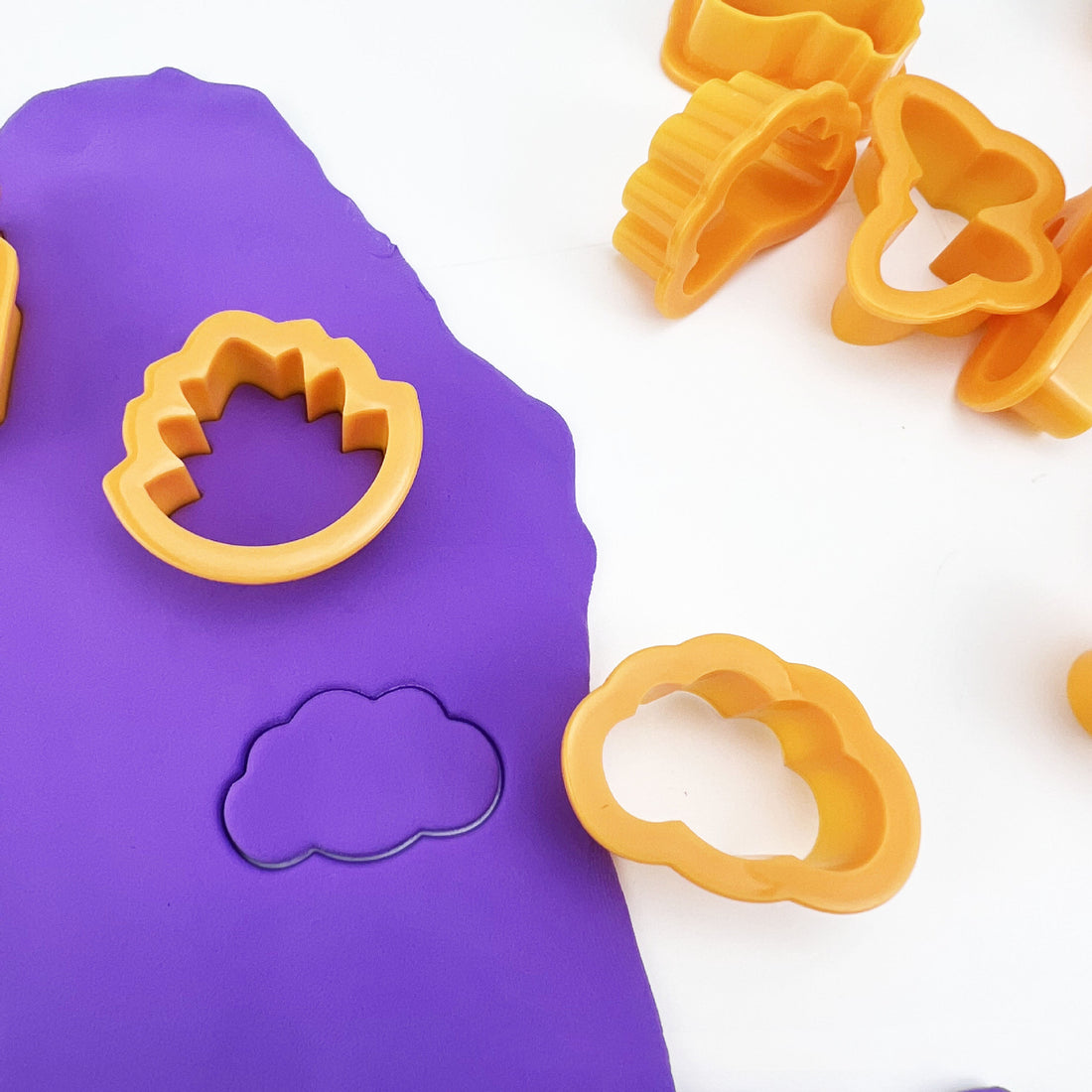 Arts And More Cutter Mold Set with yellow plastic cutters shaping purple craft clay