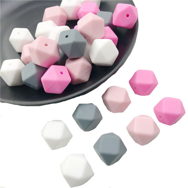 Colorful hexagon beads in pink, white, and gray from Arts And More craft materials collection