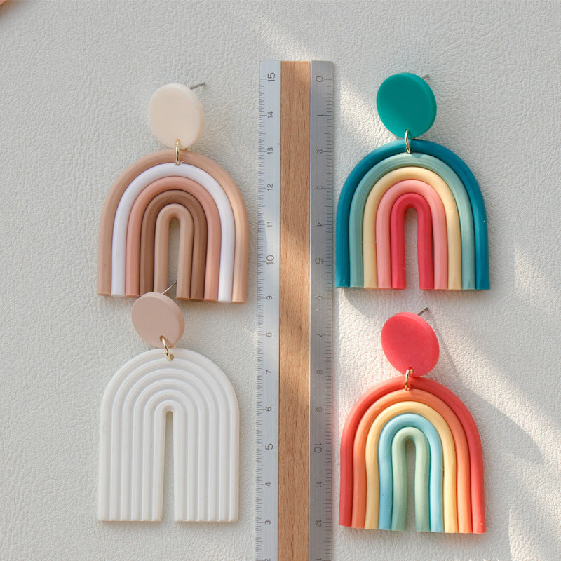 Colorful Rainbow Polymer Clay Earrings in multiple designs from Arts And More next to a ruler for size reference