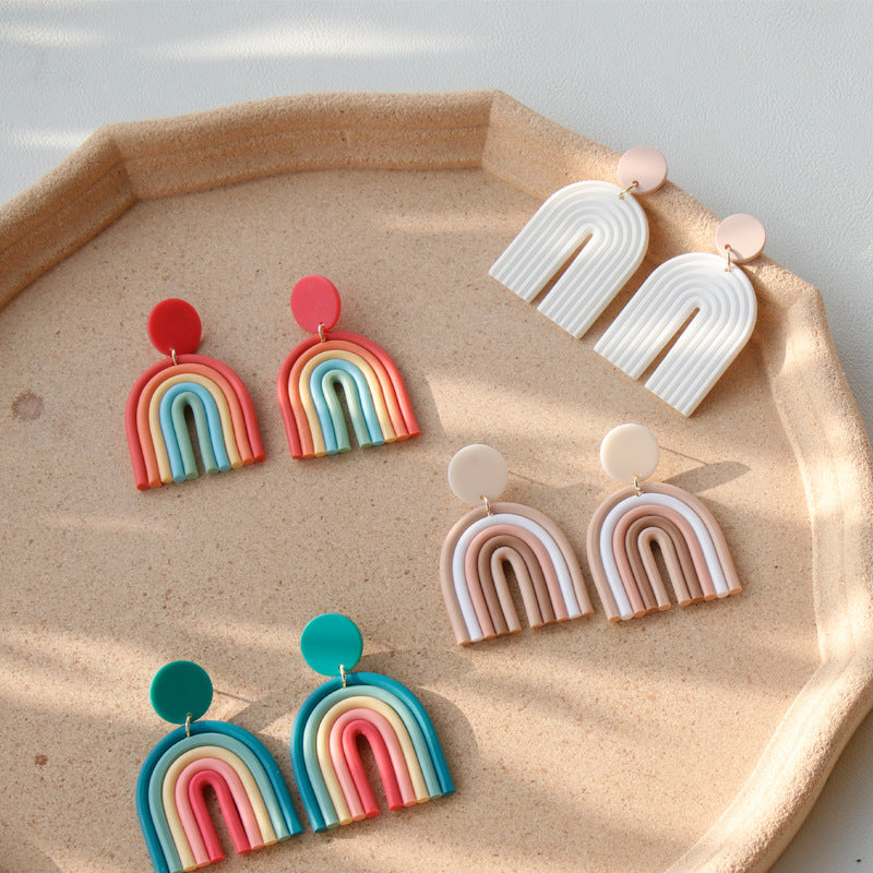 Rainbow Polymer Clay Earrings in various colors displayed on a beige decorative tray by Arts And More