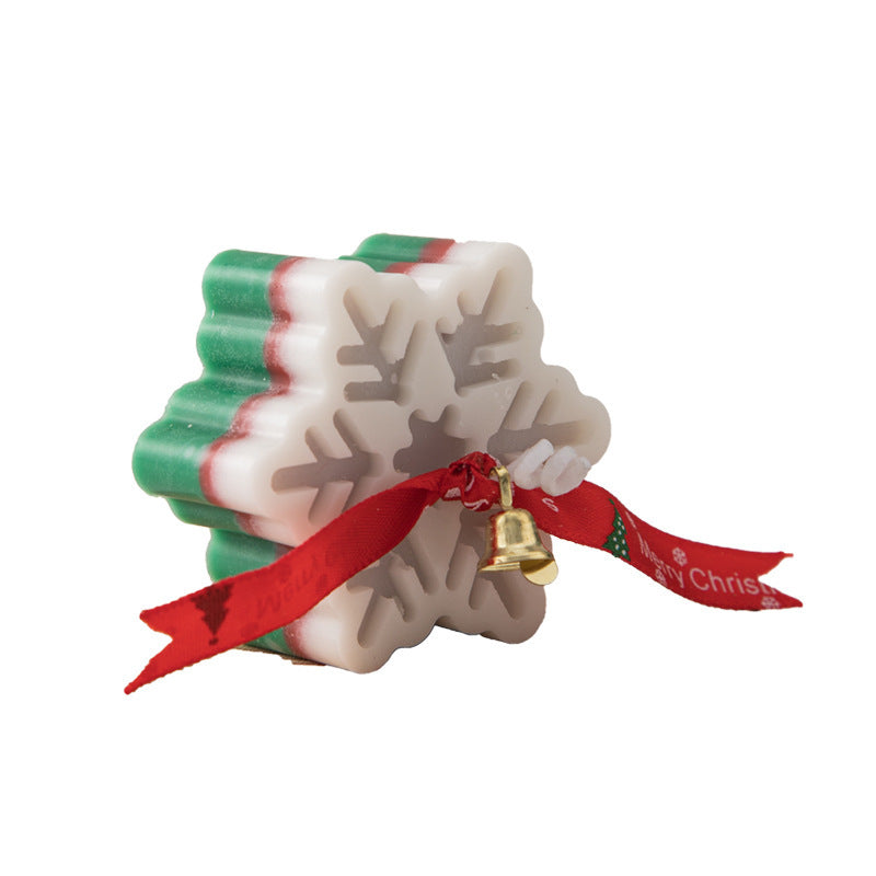 Snowflake Aromatherapy Candle in festive colors with a decorative bell and ribbon for holiday ambiance