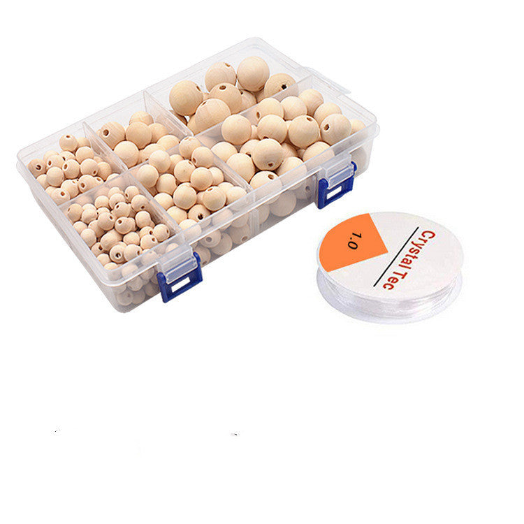 Clear box with various sizes of Wooden Round Beads and spool of clear nylon thread for crafting