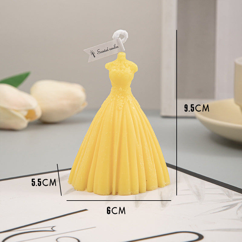 A yellow dress-shaped wedding candle from Arts And More, perfect for wedding decorations