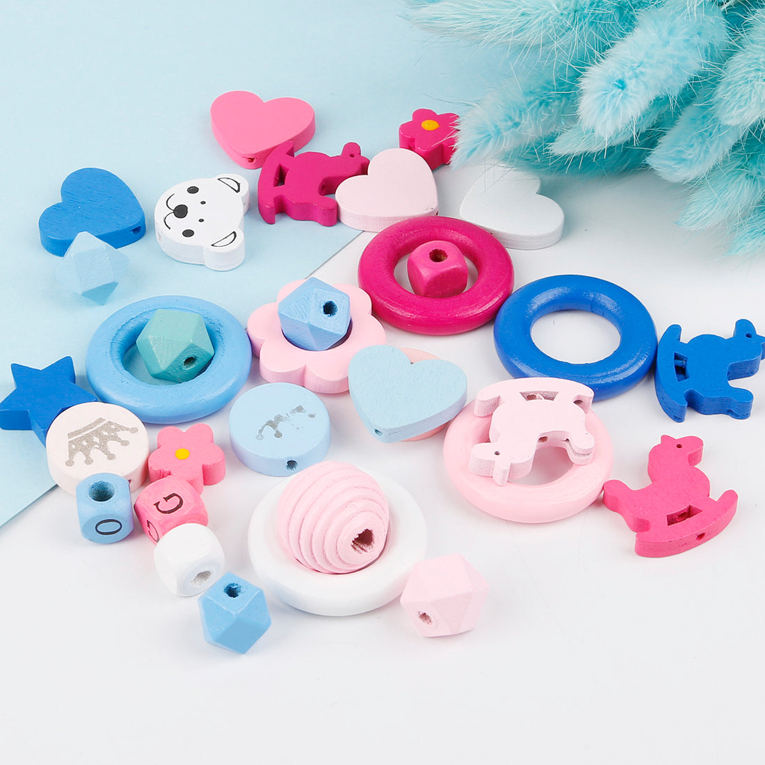 Colorful wooden beaded materials including hearts, stars, animals, and rings for crafting by Arts And More