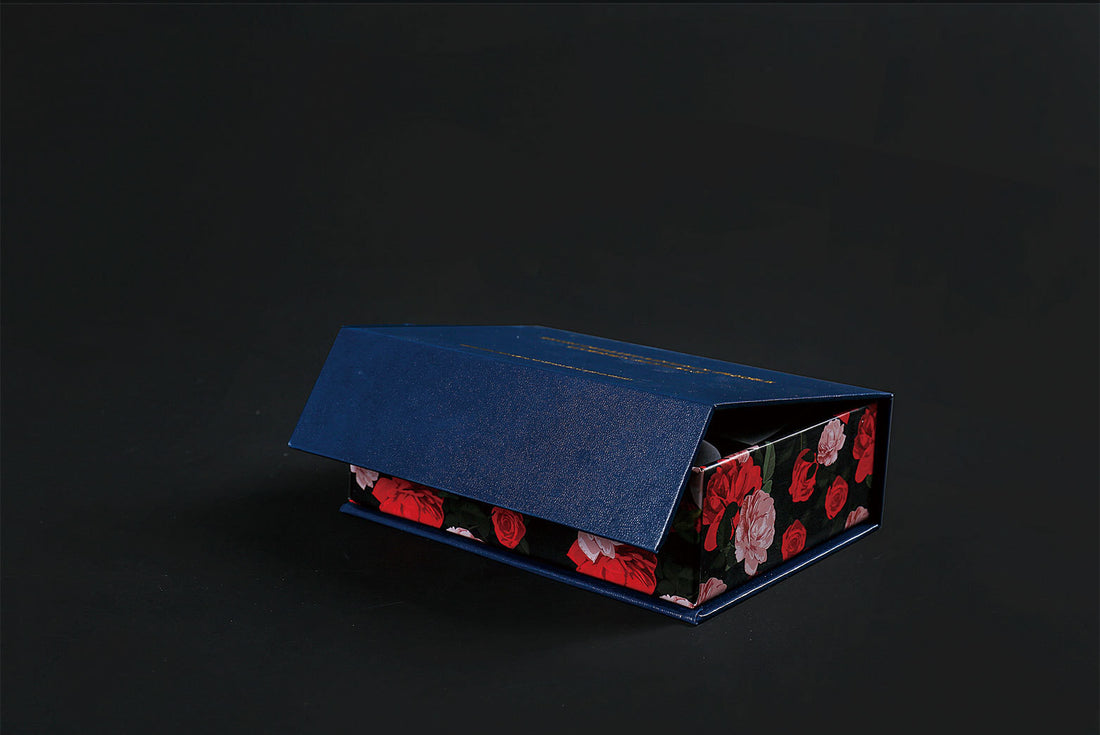 Closed blue box with floral design, packaging for Arts And More Wooden Dinosaur Puzzle arts and crafts kit