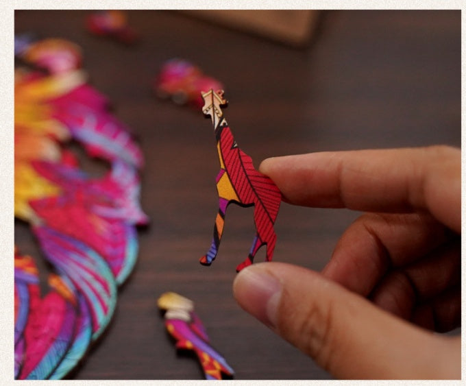 Hand holding a colorful wooden giraffe puzzle piece from Arts And More wooden puzzles kit